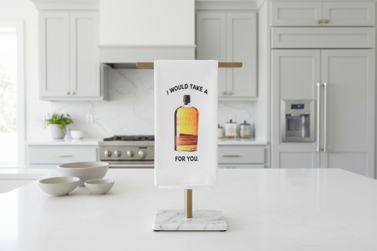 Towel with a bottle graphic and text on a stand against a gray wall.